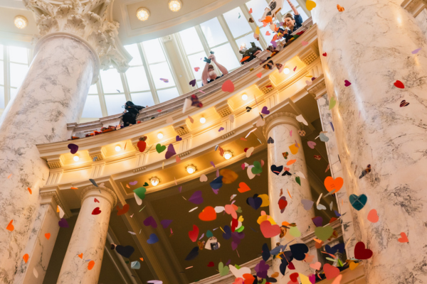 Rainbow heart are dropped down the Idaho Capitol rotunda with LGBTQ+ supportive messages.