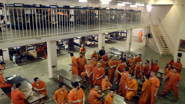 A large group a male inmates in a common space in Canyon County Jail