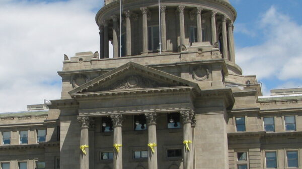 View of capitol building from afar with people standing near the steps