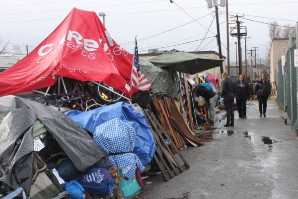 Cooper court encampment with police officers in the background