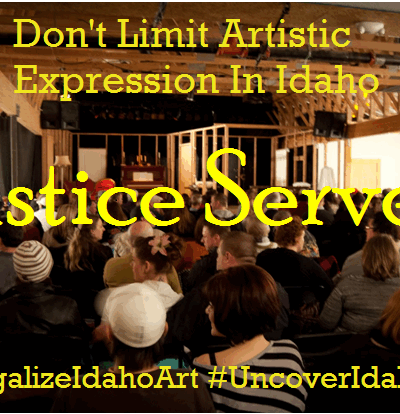 a venue with people sitting and waiting for the show to start from the back of the room, with words "Don't limit Artistic Expression in Idaho" "Justice Served" "#legalizeidahoart" and "#uncoveridahoart"