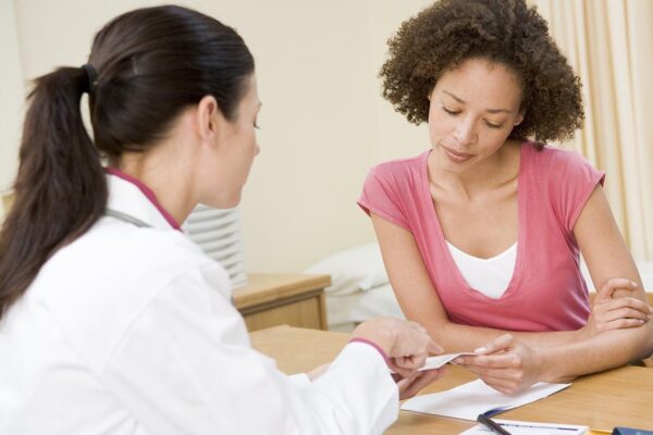 a female doctor talking to a female patient