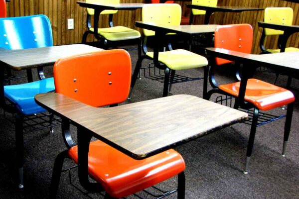 Empty school chairs and desks in a classroom