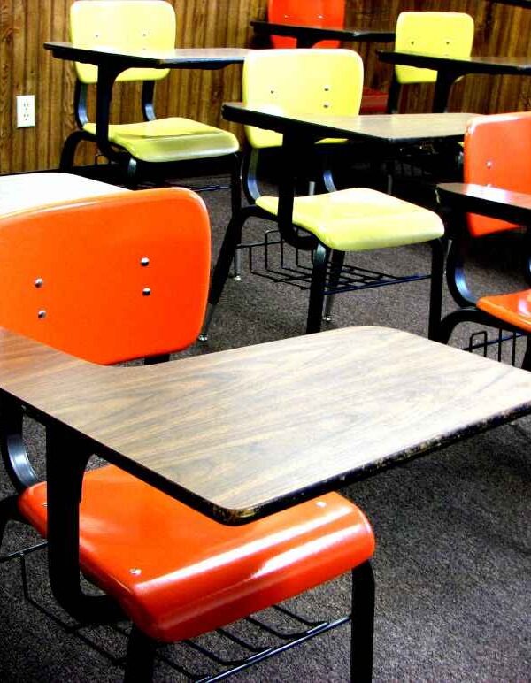 Empty school chairs and desks in a classroom