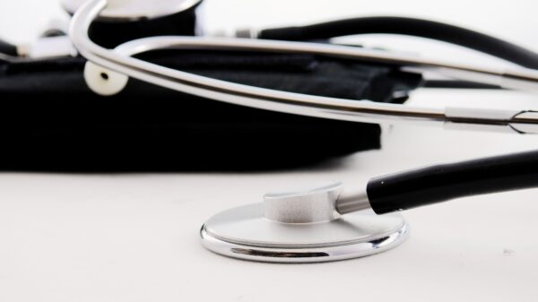 black and silver stethoscope resting on a table