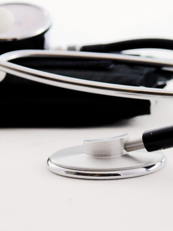 black and silver stethoscope resting on a table