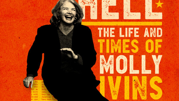 Molly Ivins in black suit laughing and sitting on the state of Texas