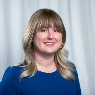 Kelsey is centered against a white cloth backdrop