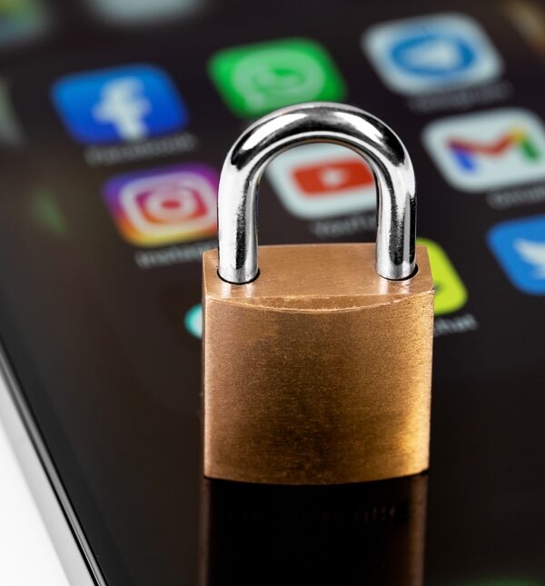 A smartphone with social media icons blocked by a padlock