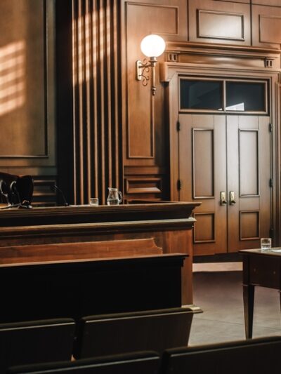 Image of a generic, empty courtroom with wood tones.