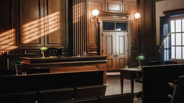 Image of a generic, empty courtroom with wood tones.