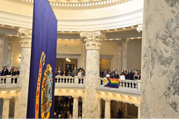 Advocates display a Pride flag inside the Idaho Capitol Rotunda
