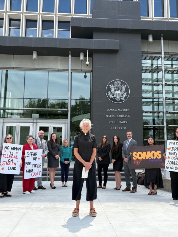 A group of activists stand outside the Idaho federal court building, led by a local Idaho pastor