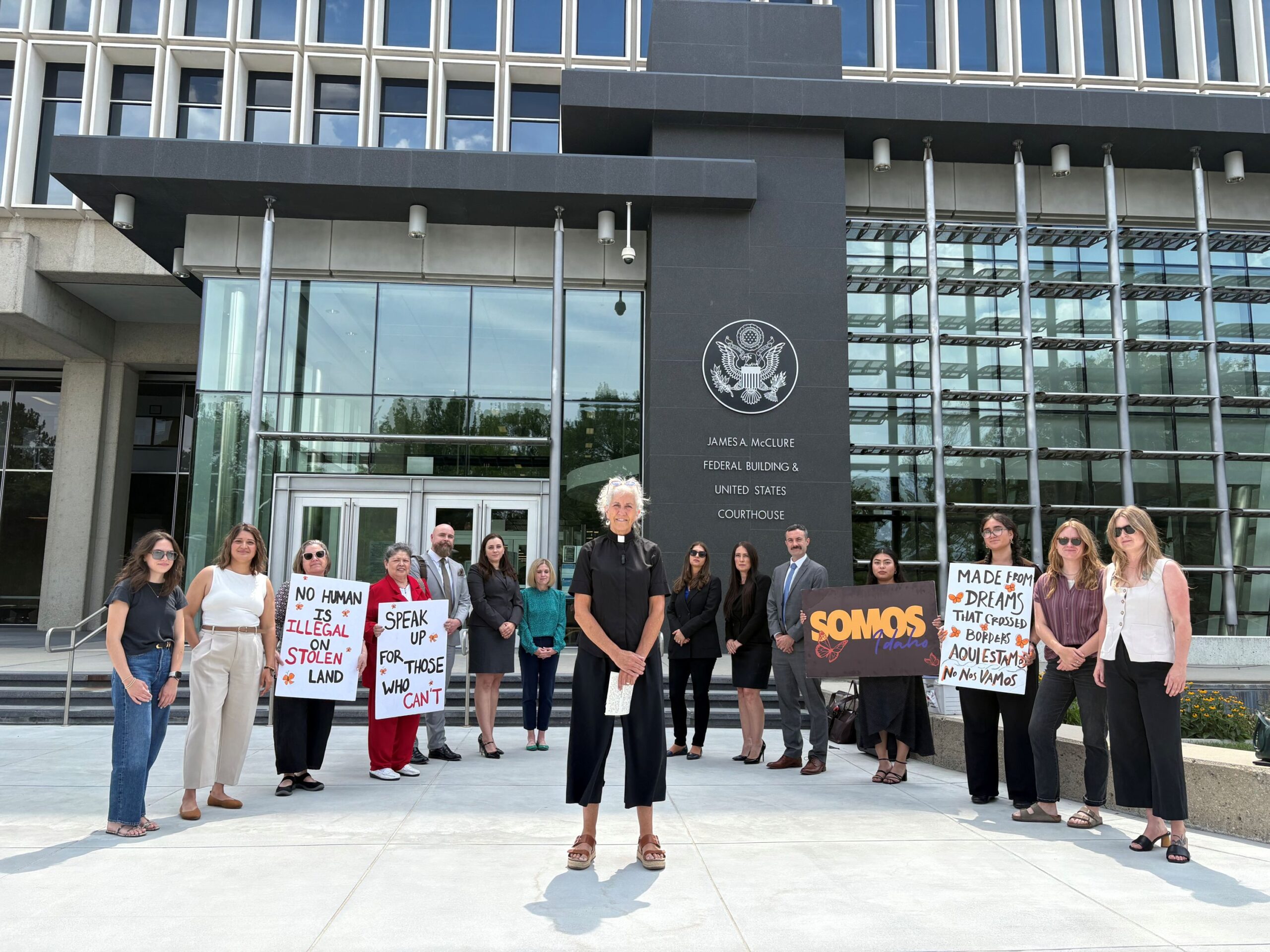 A group of activists stand outside the Idaho federal court building, led by a local Idaho pastor