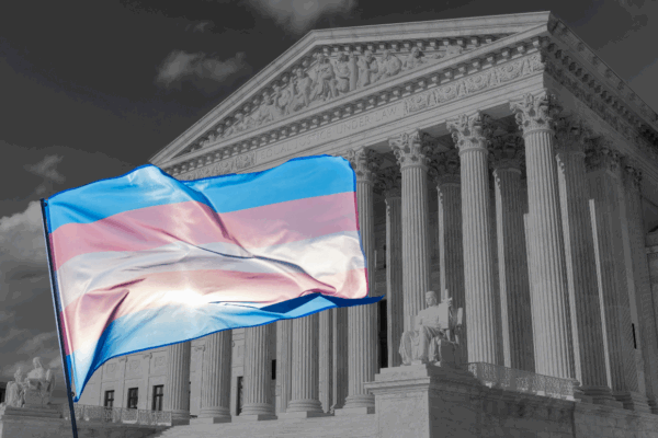 A white, blue, and pink trans flag is waving in front of a black and white image of the U.S. Supreme Court building