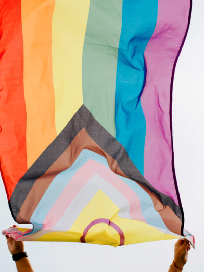 Person waving an LGBTQ+ flag
