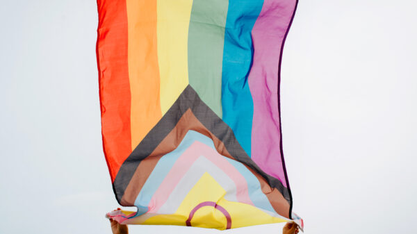 Person waving an LGBTQ+ flag