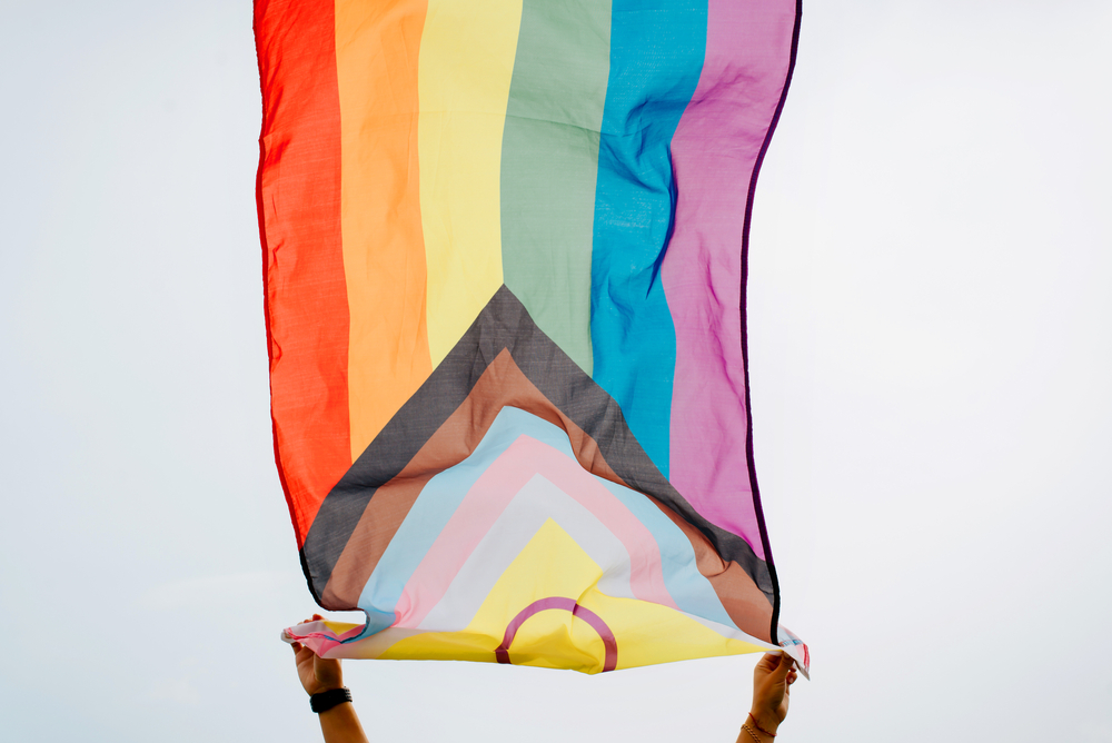 Person waving an LGBTQ+ flag