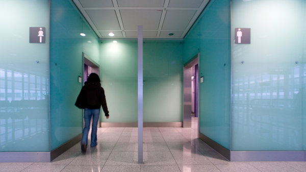 Person is walking into the women's bathroom in a public place
