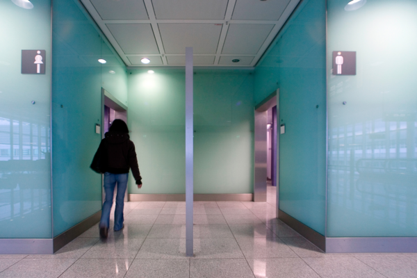 Person is walking into the women's bathroom in a public place