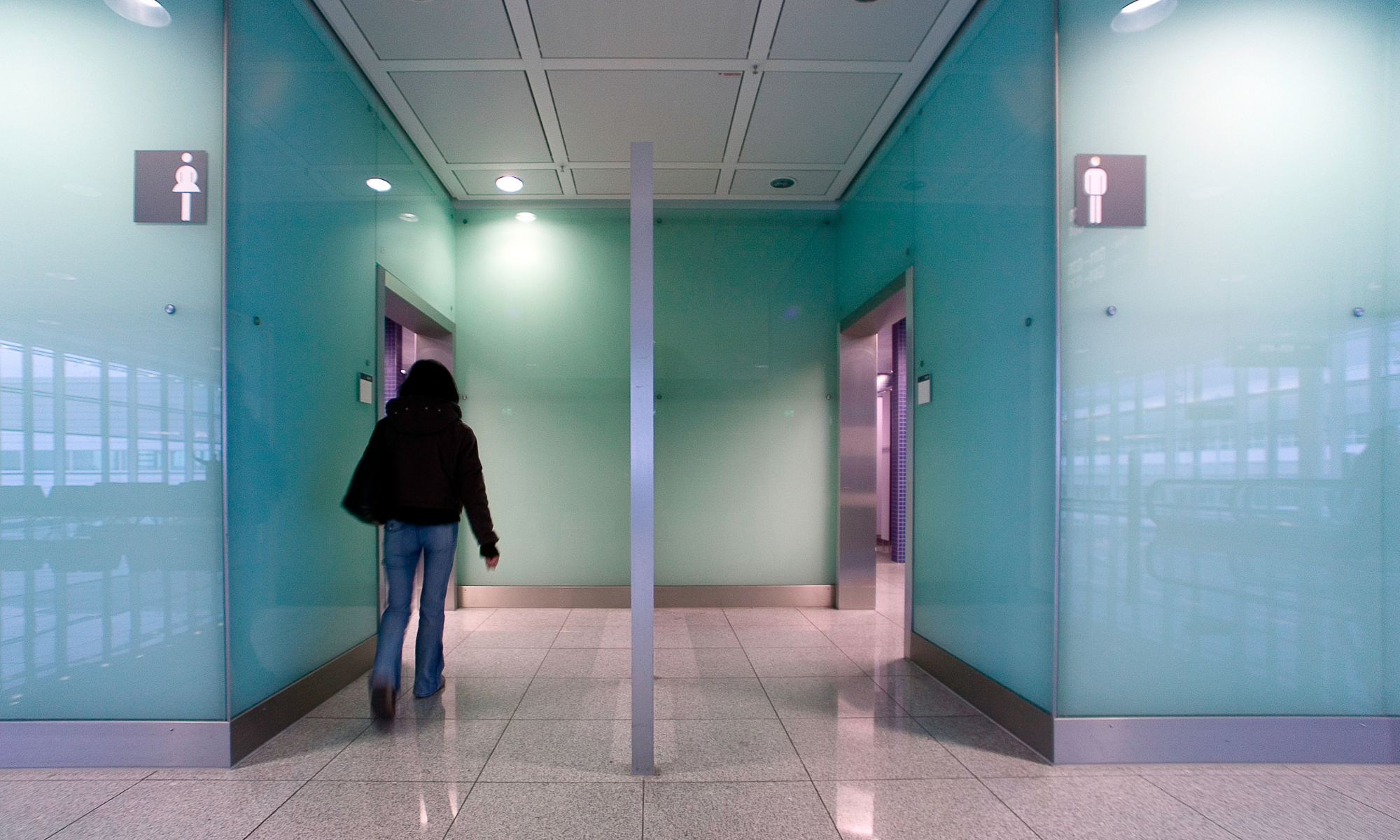 Person is walking into the women's bathroom in a public place
