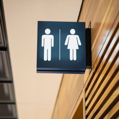 A men's/women's public bathroom lit up sign
