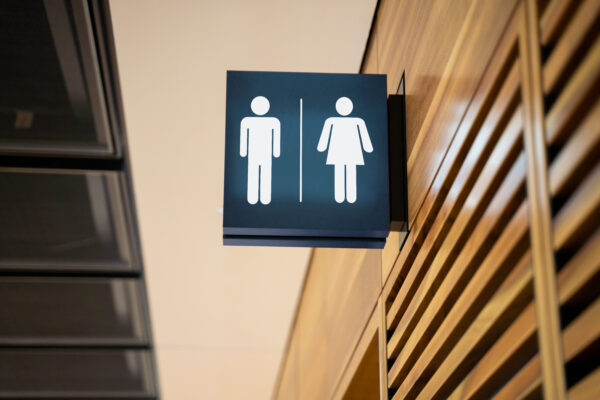A men's/women's public bathroom lit up sign