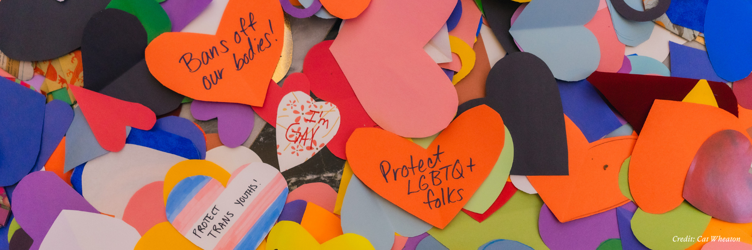 Colorful paper hearts with pro-LGBTQ messages