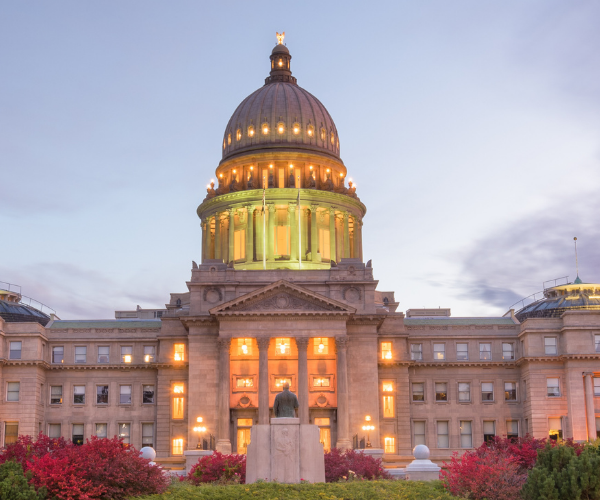 Front of the Idaho capitol lit up at dusk