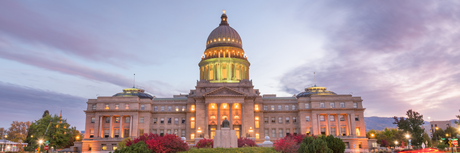 Front of the Idaho capitol lit up at dusk