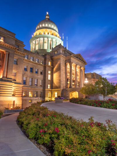 View looking up to the Idaho Capitol lit up at dusk