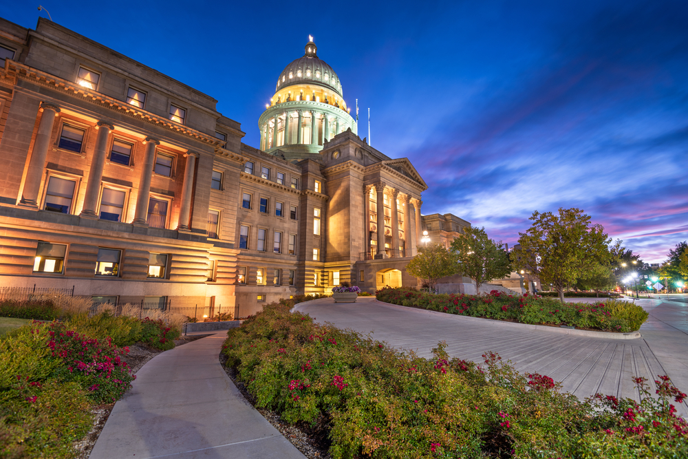 View looking up to the Idaho Capitol lit up at dusk