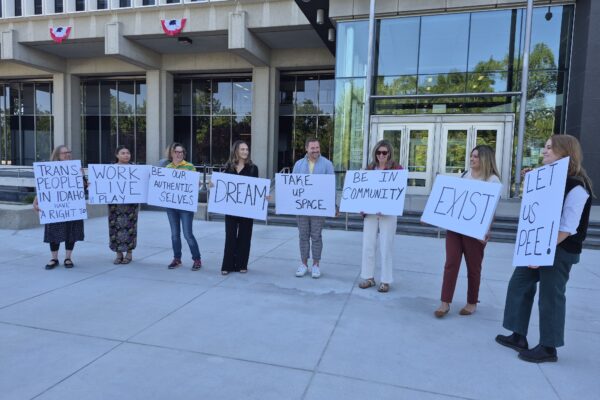 Group of pro-trans activists outside of the federal courthouse holding signs
