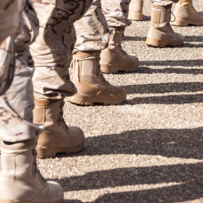Ground view of National Guard troops in uniform, with only boots and camouflage pants showing