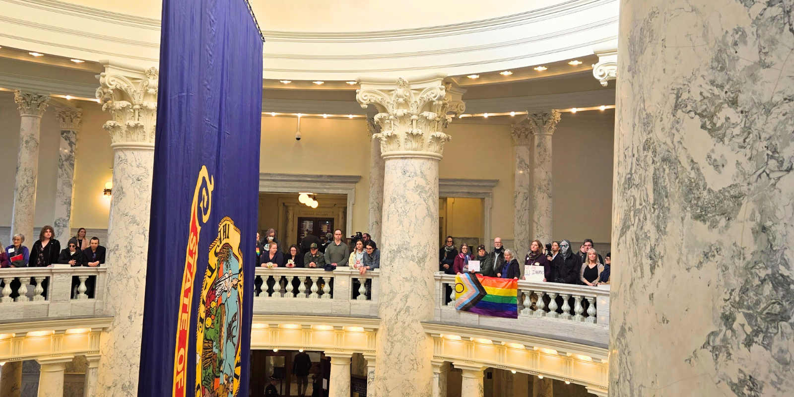 Advocates display a Pride flag inside the Idaho Capitol Rotunda