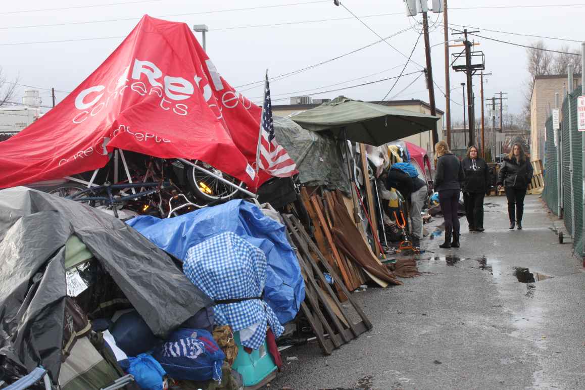 Cooper court encampment with police officers in the background 