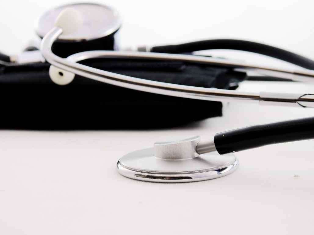 black and silver stethoscope resting on a table
