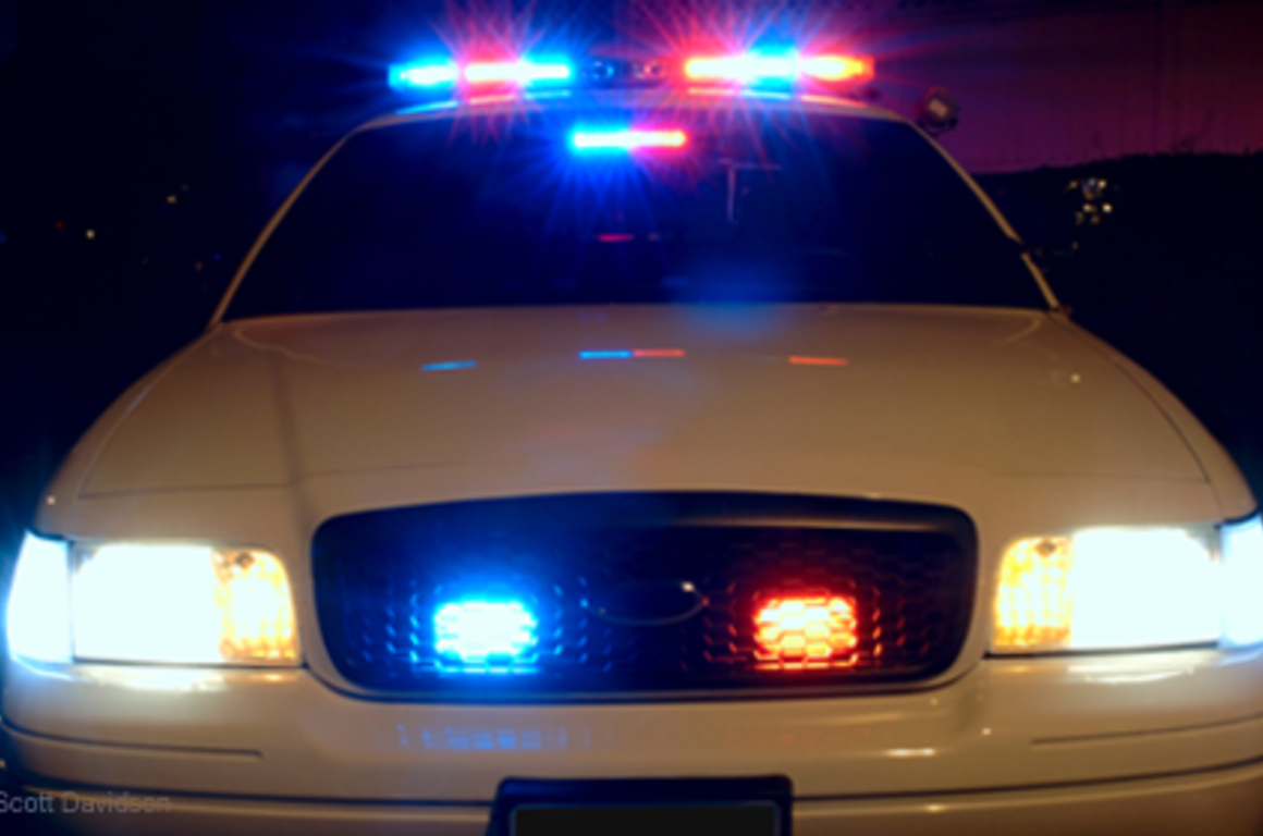 front of police car with lights on 