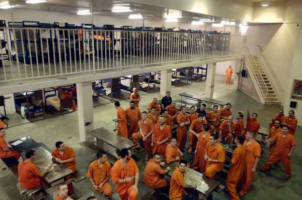 A large group a male inmates in a common space in Canyon County Jail