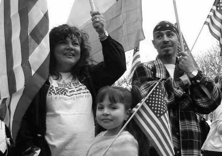 Family holding american flags and smiling