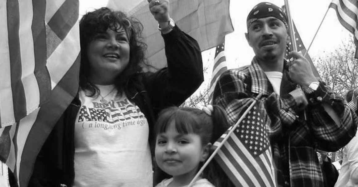 Family holding american flags and smiling