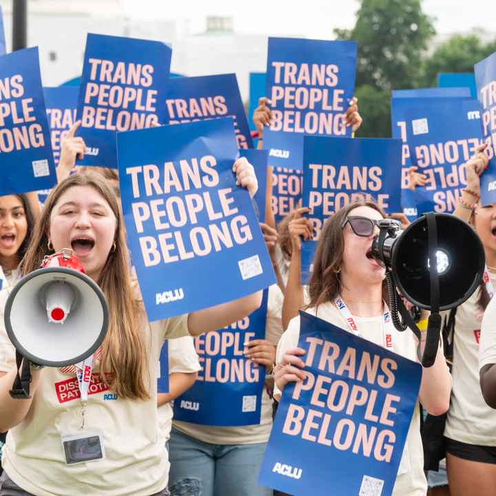 A group of young demonstrators holding ACLU signs that say Trans People Belong.